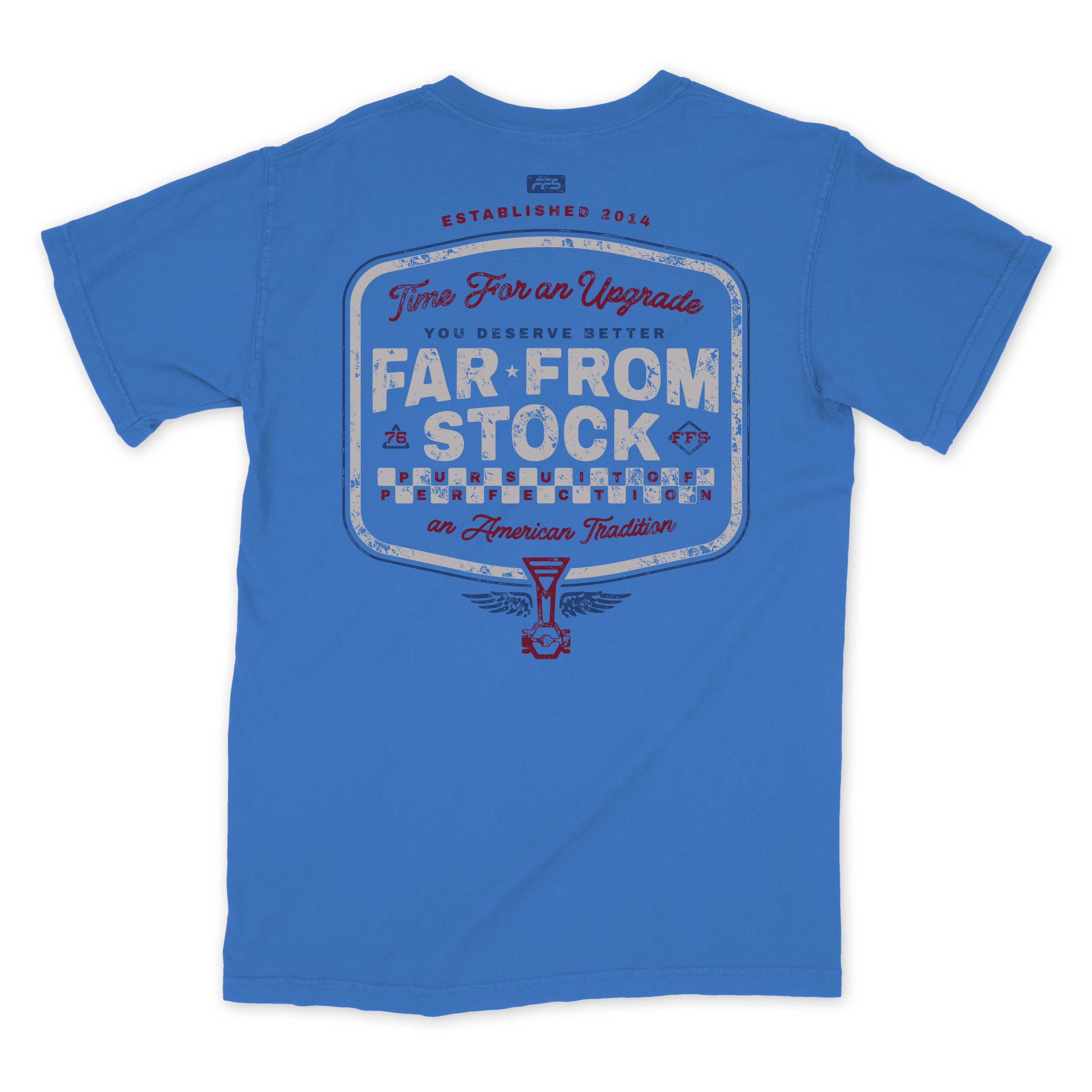 A blue short-sleeve t-shirt shown from the back, featuring a large vintage-style graphic print with the text 'Two Fish on Upgrade', 'FAR FROM STOCK', and 'an American Tradition' in distressed white, red, and blue lettering.